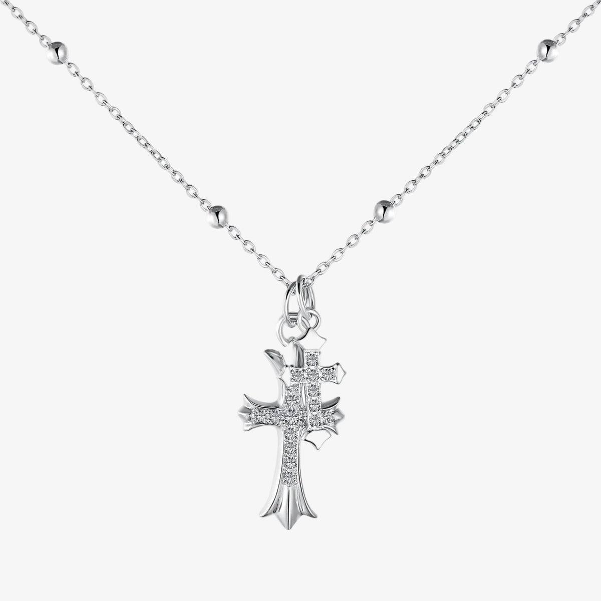 Silver cross pendant necklace on a white background