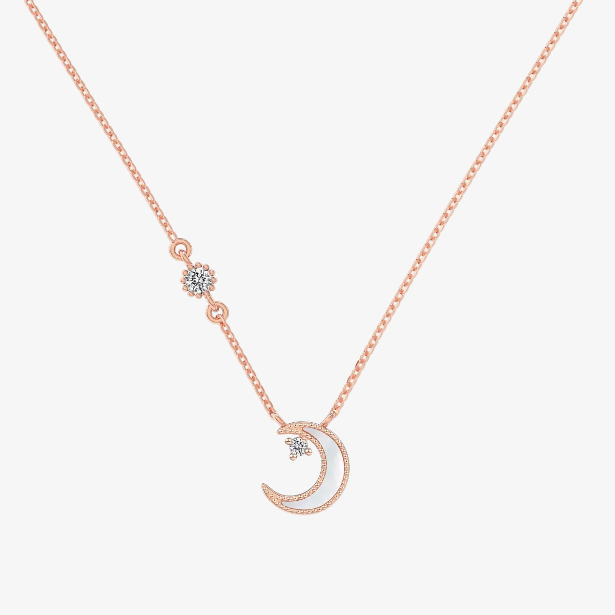 Rose gold necklace with a white crescent moon pendant on a white background